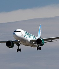 An Airbus A320neo jetliner belonging to Frontier Airlines, lands at Harry Reid International Airport in Las Vegas, Nevada, in February 2022. Frontier Airlines has announced its newest incentive to get travelers back in the air post-pandemic.
Mandatory Credit:	Larry MacDougal/MCDOL/AP