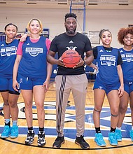 John Marshall’s lady Justices are from left, Jaedyn Cook, Khamaya early, Mia Crutchfield, Yazmin Hall, Zuri Hall and Janiyaha pickett. Standing in the middle is their coach, Virgil Burton.