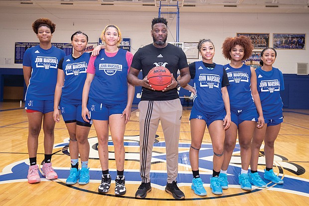 John Marshall’s lady Justices are from left, Jaedyn Cook, Khamaya early, Mia Crutchfield, Yazmin Hall, Zuri Hall and Janiyaha pickett. Standing in the middle is their coach, Virgil Burton.