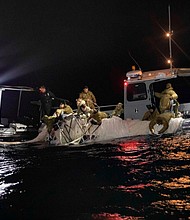 Sailors assigned to Explosive Ordnance Disposal Group 2 recover a high-altitude surveillance balloon off the coast of Myrtle Beach, South Carolina, on Sunday.
Mandatory Credit:	Petty Officer 1st Class Tyler Thompson/US Navy