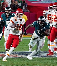 Kansas City Chiefs' quarterback Patrick Mahomes runs with the ball during Super Bowl LVII against the Philadelphia Eagles. After the game, players and fans on social media complained about the quality of the turf at State Farm Stadium.
Mandatory Credit:	Timothy A. Clary/AFP/Getty Images