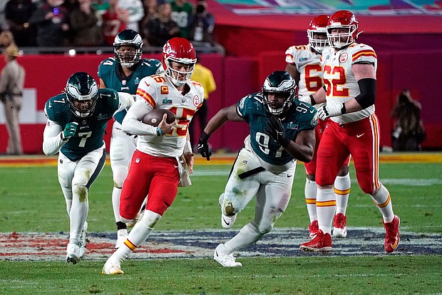 Kansas City Chiefs' quarterback Patrick Mahomes runs with the ball during Super Bowl LVII against the Philadelphia Eagles. After the game, players and fans on social media complained about the quality of the turf at State Farm Stadium.
Mandatory Credit:	Timothy A. Clary/AFP/Getty Images