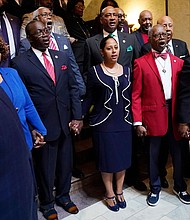 Members of the Mississippi Legislative Black Caucus hold hands and sing "We Shall Overcome" following a news conference where they expressed disappointment at the passage of House Bill 1020.
Mandatory Credit:	Rogelio V. Solis/AP