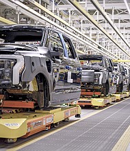 Ford uses Robotic Autonomous Guided Vehicles to move F-150 Lightning trucks from workstation to station.
Mandatory Credit:	Ford