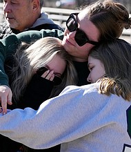 Michigan State University students embrace at The Rock on campus on February 14.
Mandatory Credit:	Carlos Osorio/AP