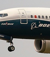 Air India will purchase more than 200 planes from Boeing. In this September 2020 photo, a Boeing 737 Max jet prepares to land at Boeing Field following a test flight in Seattle.
Mandatory Credit:	Elaine Thompson/AP/File