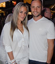 A picture taken on January 26, 2013, shows Olympian sprinter Oscar Pistorius posing next to his girlfriend Reeva Steenkamp.
Mandatory Credit:	Waldo Swiegers/AFP/Getty Images
