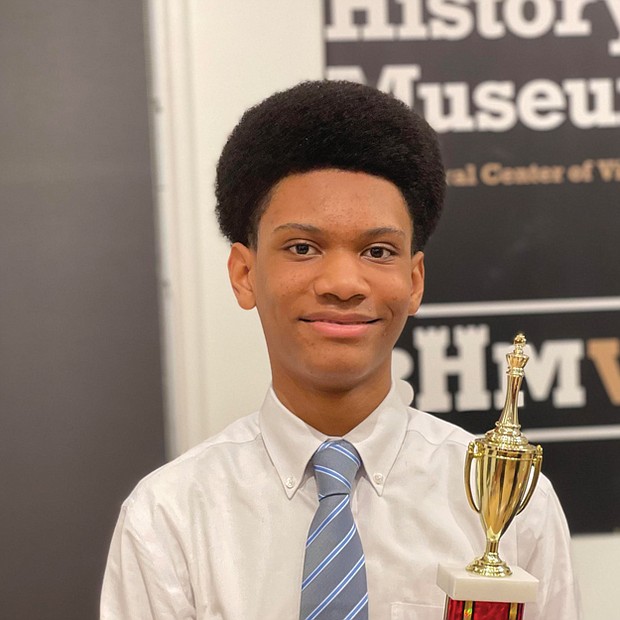 Jace Miles celebrates his victory in the 2nd Annual Bright Minds RVA Chess Tournament at the awards presentation Friday night at the Black History Museum and Cultural Center of Virginia. The 13-year-old Henderson Middle School student, the son of Michael and Otesa Miles, received a trophy and $400 for his first place showing in the four-round competition involving 10 youths. Jace started playing chess in an afternoon elementary school program. During the early days of the COVID-19 pandemic, he further developed his chess skills by playing online with a cousin who lives in New York. In between, he continued to play the game.