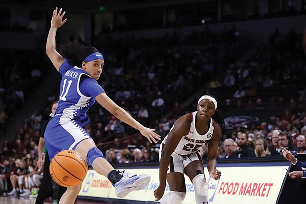 Kentucky guard Jada Walker (11) keeps her eye on the ball that was passed by South Carolina guard Raven Johnson, right, during the first half of a Feb. 2 game in Columbia, S.C.