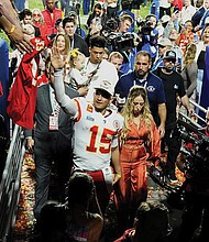 Kansas City Chiefs quarterback Patrick Mahomes (15) leaves the field Sunday with his wife, Brittany Mahomes, after Super Bowl LVII against the Philadelphia Eagles in Glendale, Ariz. The Kansas City Chiefs defeated the Philadelphia Eagles 38-35.