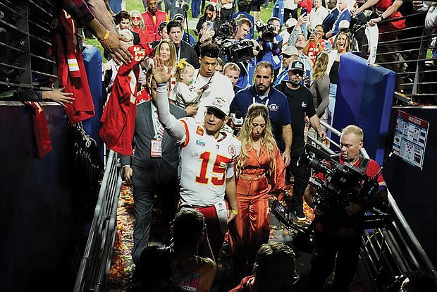 Kansas City Chiefs quarterback Patrick Mahomes (15) leaves the field Sunday with his wife, Brittany Mahomes, after Super Bowl LVII against the Philadelphia Eagles in Glendale, Ariz. The Kansas City Chiefs defeated the Philadelphia Eagles 38-35.