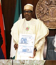 Nigeria reissues the old 200-naira ($0.43) banknotes as cash fiasco threatens to disrupt the general elections later this month. Nigerian President Muhammadu Buhari (C) is pictured here during the launch of the new currency in Abuja, Nigeria November 23, 2022.
Mandatory Credit:	Afolabi Sotunde/Reuters