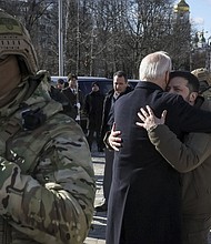 President Joe Biden and Ukraine's President Volodymyr Zelenskiy embrace after their visit to the Wall of Remembrance to pay tribute to killed Ukrainian soldiers, in Kyiv, Ukraine, February 20.
Mandatory Credit:	Gleb Garanich/Reuters