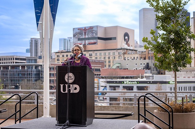 Rep. Senfronia Thompson, with the mural with her eyes in the background, speak at the Remembrance Murals unveiling event that also honored her for her public service.