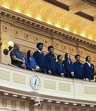 From left, John Marshall High School basketball Coach Ty White, Athletic Director Danielle Smith stand at the Virginia General Assembly with players Tyrell Allmond, Makeyon Hill, Robert Jones (manager), Damon Thompson Jr., Dominique Bailey and Nito West.