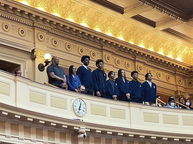 From left, John Marshall High School basketball Coach Ty White, Athletic Director Danielle Smith stand at the Virginia General Assembly with players Tyrell Allmond, Makeyon Hill, Robert Jones (manager), Damon Thompson Jr., Dominique Bailey and Nito West.