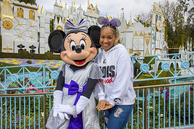 Award-winning singer and radio show host Erica Campbell shares a magical moment with Minnie Mouse in front of “it’s a small world,” before taking the stage as the headlining talent of “Celebrate Gospel” at Disneyland Park in Anaheim, Calif., on Feb. 25, 2023. “Celebrate Gospel” is part of Celebrate Soulfully at Disneyland Resort, where guests are invited to join a soulful celebration of Black heritage and culture through experiences, music, food and more. (Christian Thompson/Disneyland Resort)