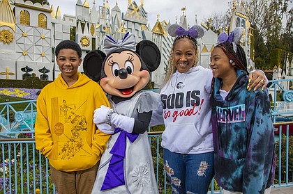 Award-winning singer and radio show host Erica Campbell and her family enjoy an unforgettable day at Disneyland Park in Anaheim, Calif., before she takes the stage as the headlining talent of “Celebrate Gospel” on Feb. 25, 2023. Erica and her kids, Zaya and Warryn, share a magical moment with Minnie Mouse in front of “it’s a small world.” “Celebrate Gospel” is part of Celebrate Soulfully at Disneyland Resort, where guests are invited to join a soulful celebration of Black heritage and culture through experiences, music, food and more. (Christian Thompson/Disneyland Resort)