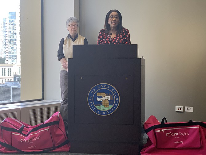 Cook County Commissioner Donna Miller, with Cook County Commissioner Maggie
Trevor, discussing the importance of CPR Training. PHOTO BY TIA CAROL JONES.