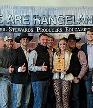 Seven members of the Texas A&M Range Club pose with a fourth place plaque.