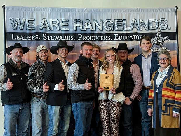 Seven members of the Texas A&M Range Club pose with a fourth place plaque.