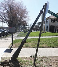 A city street sign leans at the corners of Shirley Lane and Westover Road in Richmond’s Byrd Park on March 4. A nearby hole is equally dangerous. Hopefully an employee in the City of Richmond’s Department of Public Works soon will attend to this potentially hazardous situation.