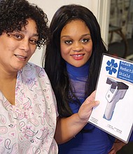 Casaundra L. Pugh, left, and her daughter, Younniaa I.J. Williams, show a photo of their invention, a glare-reduction shield for digital thermometers.