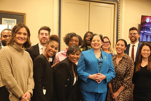 During a private gathering prior to Rep. Jennifer L. McClellan’s official swearing-in ceremony, she poses for a group photo with her new Congressional staff, many of whom served on the late Rep. A. Donald McEachin’s staff.
