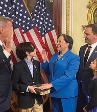 House Speaker Kevin McCarthy, left, speaks during a ceremonial swearing-in of Rep. Jennifer
L. McClellan on Capitol Hill, as her 12-year-old son, Jackson Mills, holds a family Bible from Rep. McClellan’s father, James F. McClellan Jr. Her husband, David Mills and their daughter, Samantha, 7, proudly take in the historical moment. Rep. McClellan succeeds the late Rep. A. Donald McEachin who died last November after a long battle with cancer. Rep. McClellan is the first Black woman to represent the Commonwealth of Virginia in the U.S. Congress.