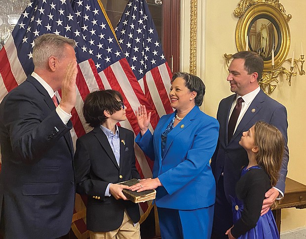 House Speaker Kevin McCarthy, left, speaks during a ceremonial swearing-in of Rep. Jennifer
L. McClellan on Capitol Hill, as her 12-year-old son, Jackson Mills, holds a family Bible from Rep. McClellan’s father, James F. McClellan Jr. Her husband, David Mills and their daughter, Samantha, 7, proudly take in the historical moment. Rep. McClellan succeeds the late Rep. A. Donald McEachin who died last November after a long battle with cancer. Rep. McClellan is the first Black woman to represent the Commonwealth of Virginia in the U.S. Congress.