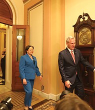 House Speaker Kevin McCarthy, right, leads Rep. Jennifer L. McClellan into a room on Capitol Hill for the ceremonial swearing-in filled with news photographers to document the moment with her husband, David Mills and two children, Jackson (12) and Samantha (7), who were waiting for them to arrive Tuesday.