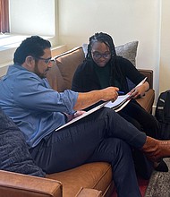 State Rep. Armando Walle, left, reviews materials with Jesha Magee, 27, who participates in Harris County Commissioner Rodney Ellis’ Texas Legislative Internship Program in Austin.