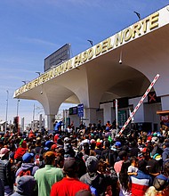Migrants amassed at the Paso del Norte international bridge on March 12.
Mandatory Credit:	Jose Luis Gonzalez/Reuters