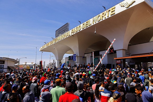 A large group of people in Mexico approached a US border entry point in El Paso, Texas, Sunday in an …