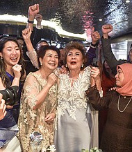 Janet Yeoh (center R), mother of actress Michelle Yeoh, celebrated her daughter's historic Oscar win on March 12.
Mandatory Credit:	Arif Kartono/AFP/Getty Images