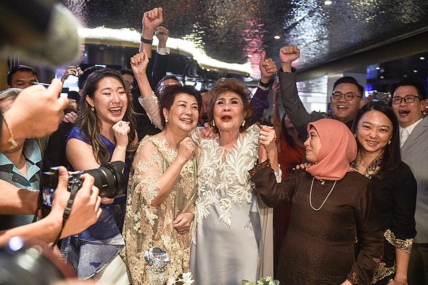 Janet Yeoh (center R), mother of actress Michelle Yeoh, celebrated her daughter's historic Oscar win on March 12.
Mandatory Credit:	Arif Kartono/AFP/Getty Images