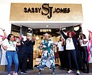 Sassy Jones is a multi-million dollar brand that designs customized jewelry, clothing and accessories with Black women in mind. Here (middle) she is at her Short Pump Town Center location.