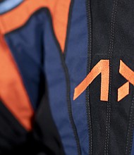 Axiom Space, which holds the contract to develop spacesuits for NASA's Artemis Program, included its logo and company colors on a top cover over the spacesuits.
Mandatory Credit:	Axiom Space