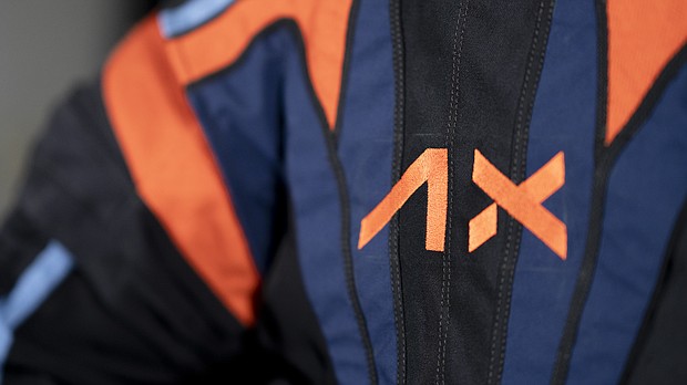 Axiom Space, which holds the contract to develop spacesuits for NASA's Artemis Program, included its logo and company colors on a top cover over the spacesuits.
Mandatory Credit:	Axiom Space