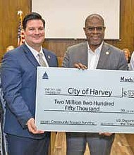 Mayor Christopher J. Clark welcomed representatives from the
Office of Congresswoman Robin Kelly to the city council meeting
on Monday, March 13, to present two ceremonial checks.