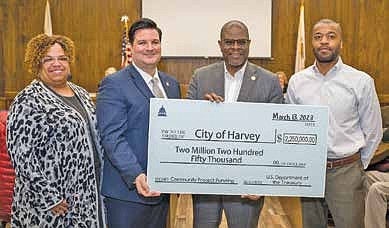 Mayor Christopher J. Clark welcomed representatives from the
Office of Congresswoman Robin Kelly to the city council meeting
on Monday, March 13, to present two ceremonial checks.