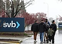People walk through the parking lot at the Silicon Valley Bank headquarters in Santa Clara, Calif., on March 10, 2023. The bank suffered a run on deposits that led to its collapse. (Justin Sullivan/Getty Images)