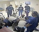 This video clip provided by Central State Hospital/Dinwiddie County, Va. shows deputies and hospital employees on top of Irvo Otieno, who lies on the floor at Central State Hospital, on March 6, 2023 in Petersburg, Va. Footage obtained Tuesday, March 21, which has no audio, shows various sheriff’s deputies and employees attempting to restrain a handcuffed and shackled Mr. Otieno for about 20 minutes after he’s led into a room at the hospital, where he was going to be admitted.
