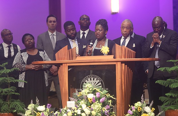 Caroline A. Ouko, the mother of 28-year-old Irvo Noel Otieno speaks Wednesday during her son’s funeral at First Baptist Church of South Richmond, Ironbridge, in North Chesterfield County. Standing with her is her eldest son, left, Leon Ochieng, and right, the Rev. Al Sharpton and Benjamin Crump.