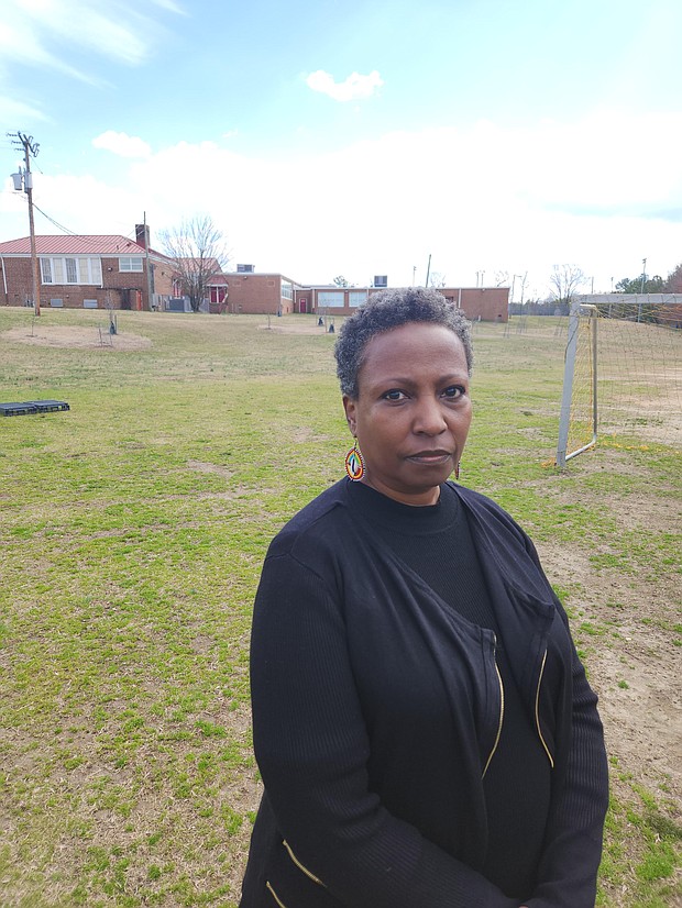 The Rev. Monica Esparza stands on land at Hickory Hill Community Center where the city Fire Department wants to build a new fire training facility. She is among the opponents who want to keep the space green and undisturbed.