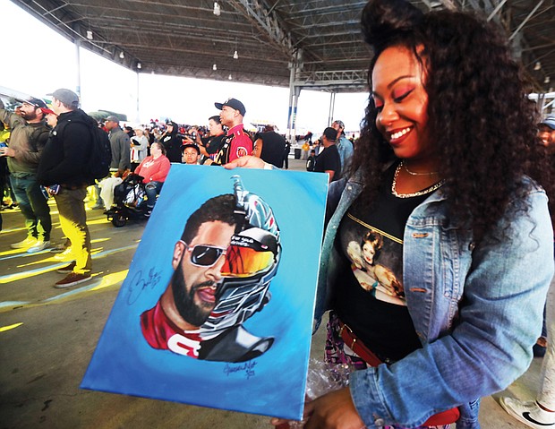 Virginia artist Gina Net painted a stylized portrait of Bubba Wallace and had him sign it during the block party.