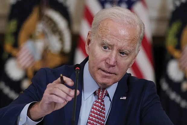 President Biden adjusts his microphone Tuesday during a meeting with the President’s Council of Advisors on Science and Technology in the State Dining Room of the White House.