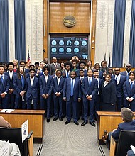 The John Marshall High School Basketball Team stands proudly at the Richmond City Council meeting March 27 to accept accolades. The team won the state championship and also has been ranked No. 1 among the nation’s high schools.