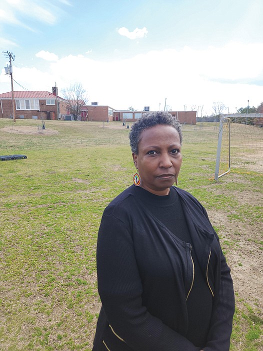 The Rev. Monica Esparza stands on land at the Hickory Hill Community Center where the Fire Department wanted to build a new fire training facility. She is among the opponents who want to keep the space green and undisturbed.