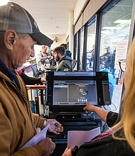 Shasta County resident Teresa Romero, 64, right, points out to her husband Charles, 68, how the number increased by one on a Dominion voting machine to indicate that his ballot was successfully scanned after being entered into the machine at the Shasta County Clerk & Elections office in Redding, California.
Mandatory Credit:	Mel Melcon/Los Angeles Times/Getty Images